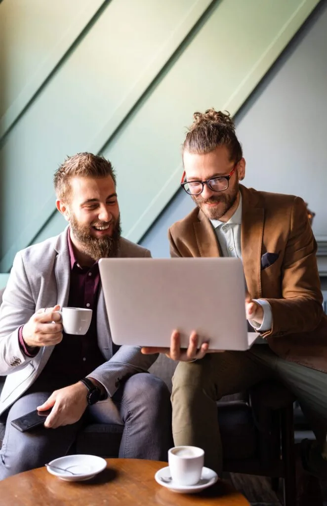 Two colleagues talking over a laptop